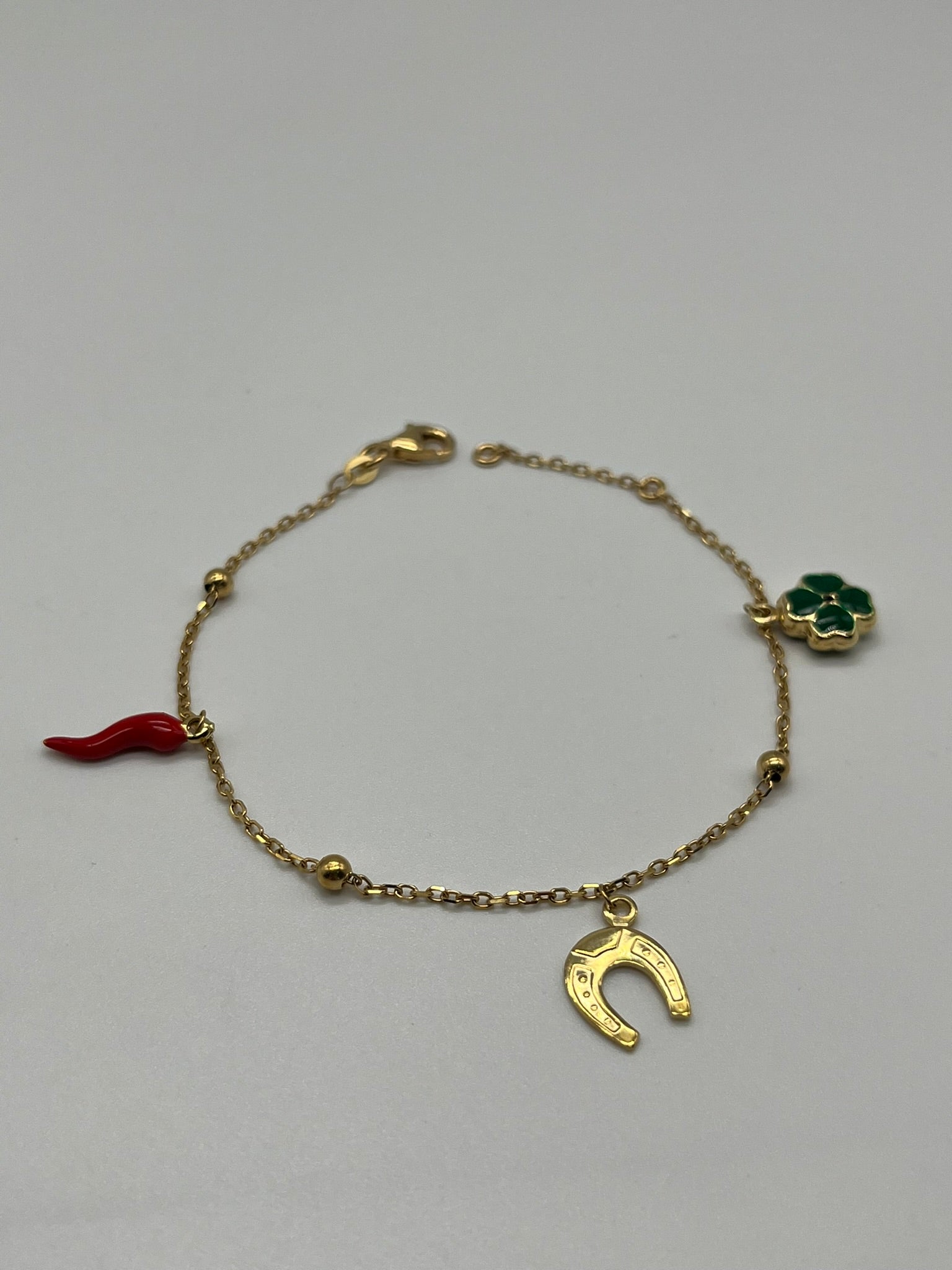 Bracciale in oro giallo 18kt con simboli portafortuna